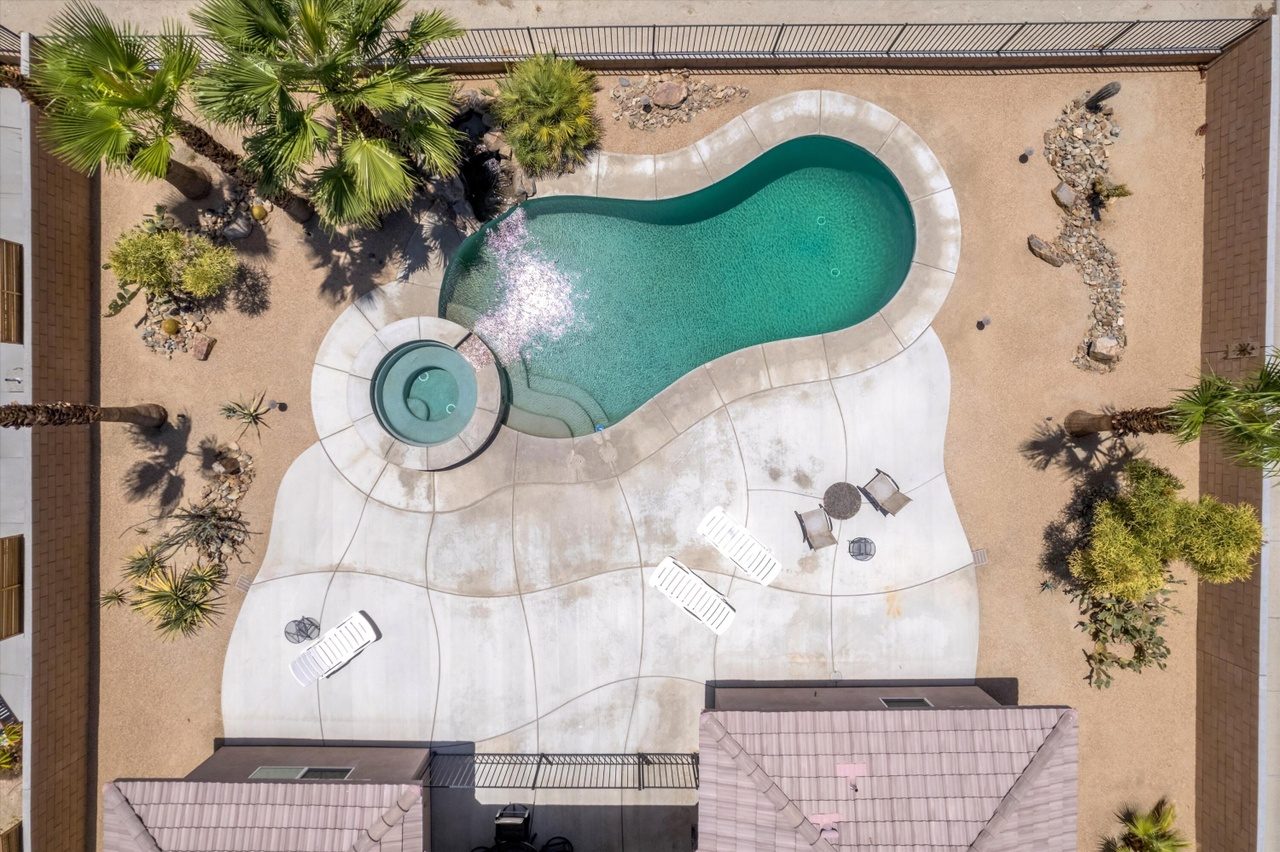 Aerial view of the backyard pool and golf course at Palms Place Indio