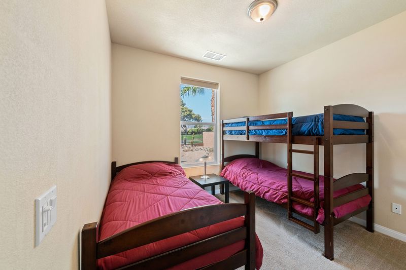 Kids room with bunk bed and twin beds at Palms Place