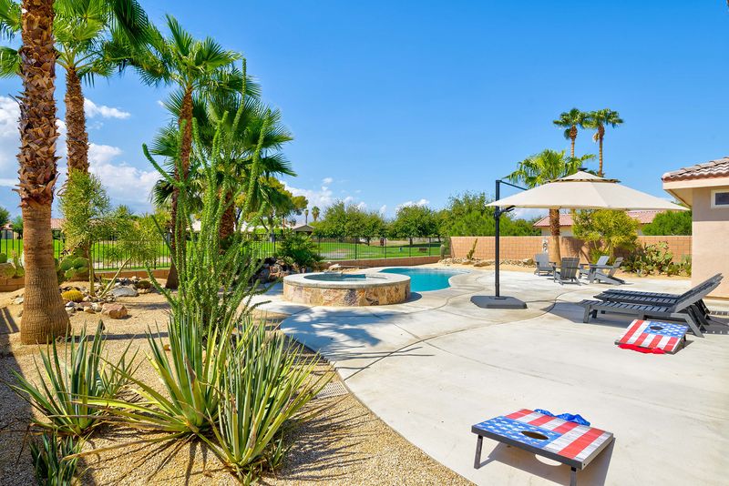 Cornhole set in the backyard at Palms Place Indio