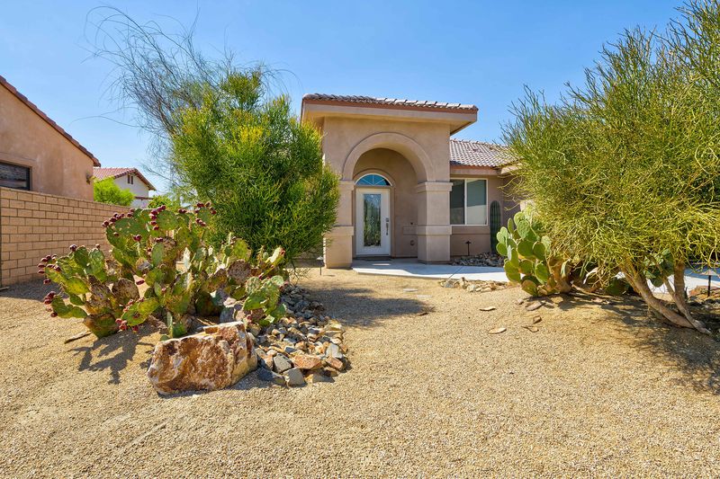 Front exterior with desert landscaping at Palms Place, Indio CA