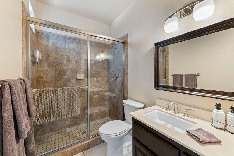 Guest bathroom with walk-in shower at Palms Place