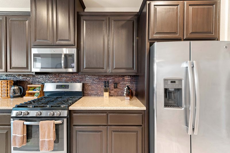 Fully stocked kitchen with stainless appliances at Palms Place