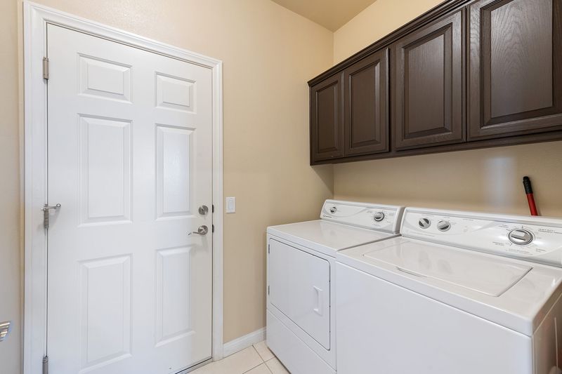 Laundry room with full-size washer and dryer at Palms Place