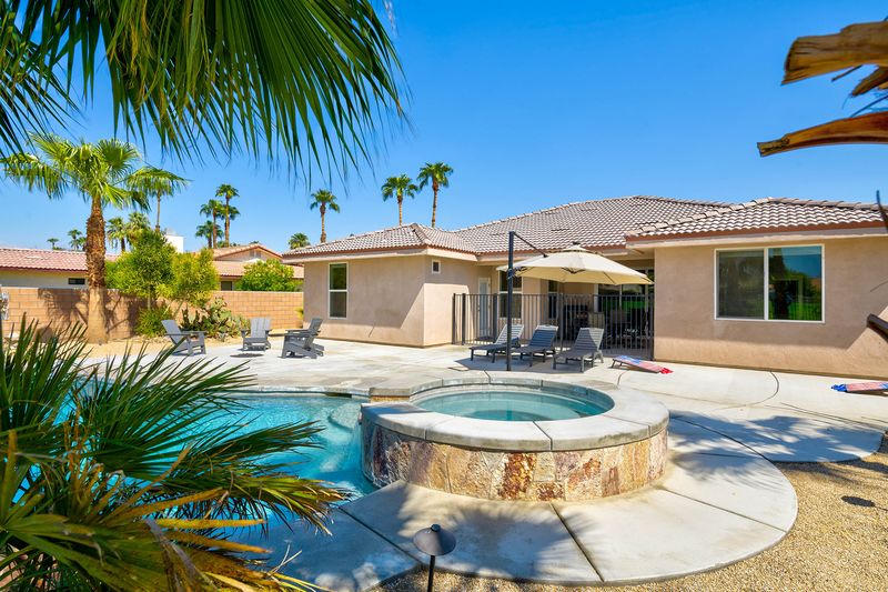 Pool and spa with mountain backdrop at Palms Place Indio