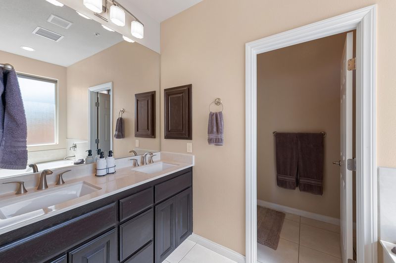 Primary bathroom double vanity at Palms Place Indio