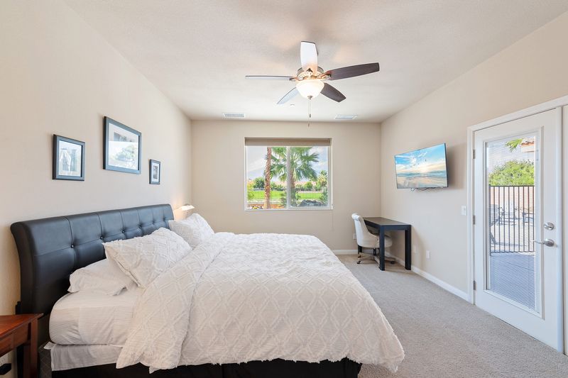 Primary suite king bed with patio access at Palms Place