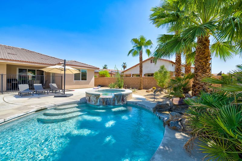 Private heated pool and spa on a sunny day at Palms Place Indio
