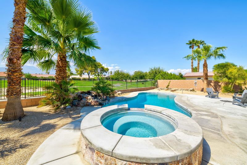 Spa with palm trees and golf course view behind Palms Place